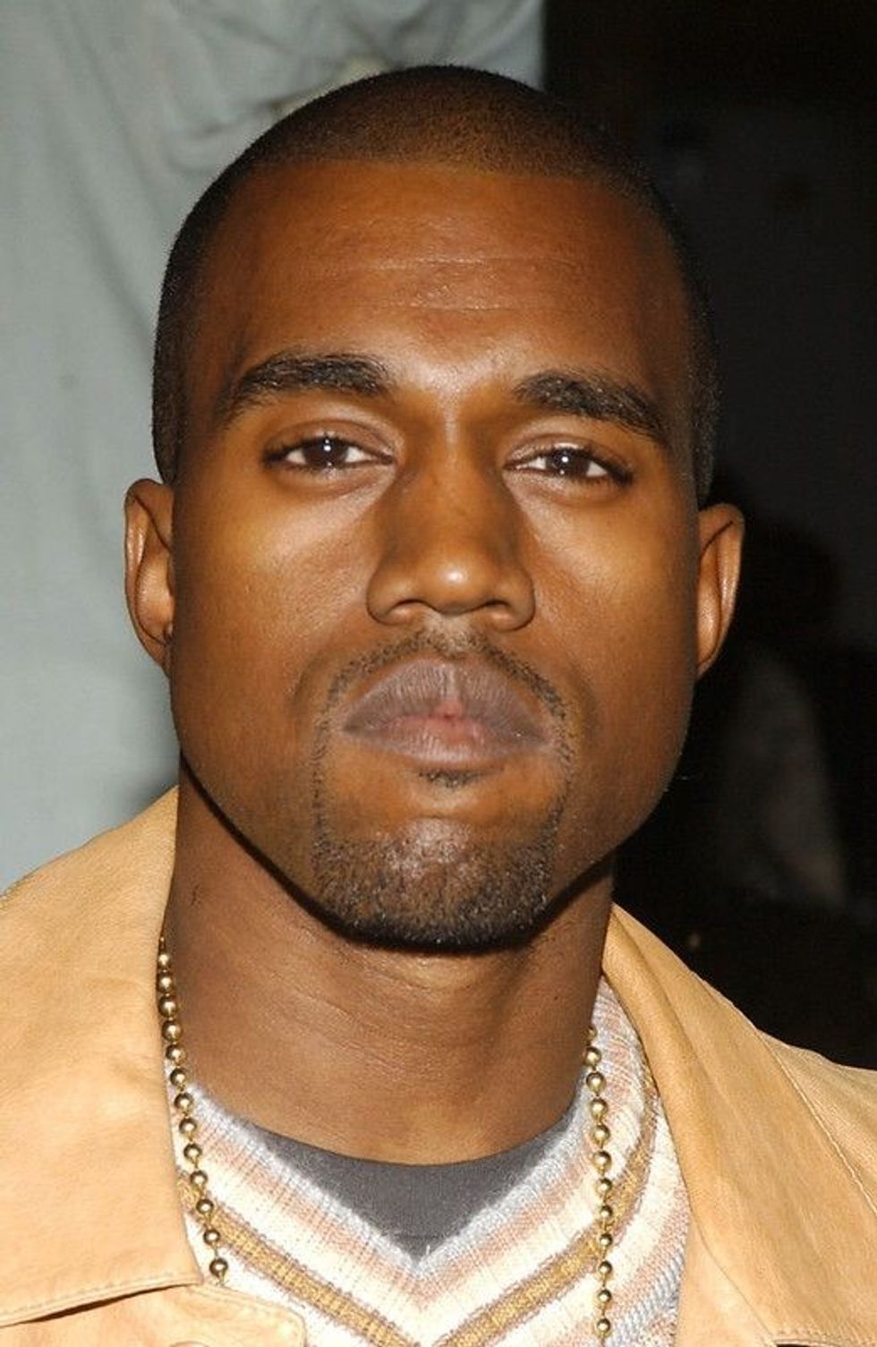 Kanye West in yellow jacket