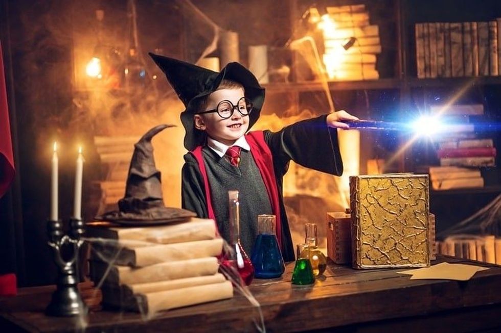 Kid doing magic trick with a magic stick