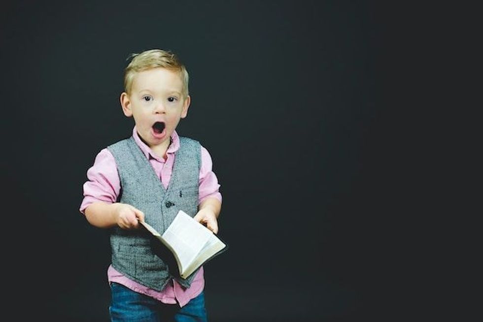Kid dressed in formals with black background