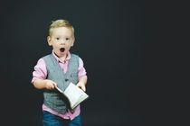 Kid dressed in formals with black background