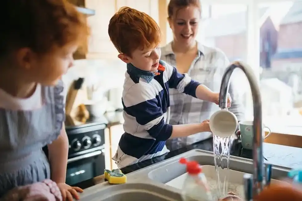 kid learning to wash up