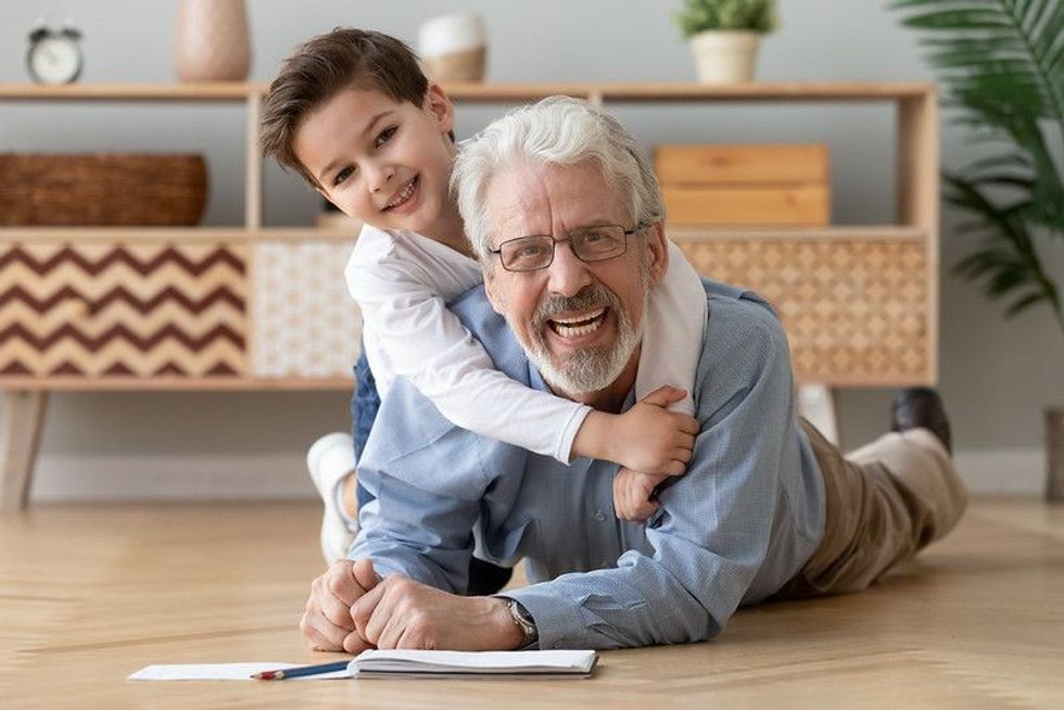 Kid playing with grandfather