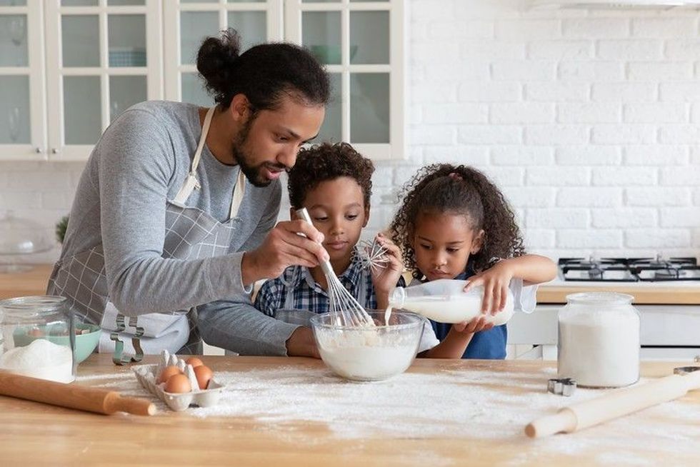 Kids baking cake with father