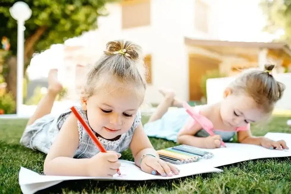 Kids drawing in the garden.