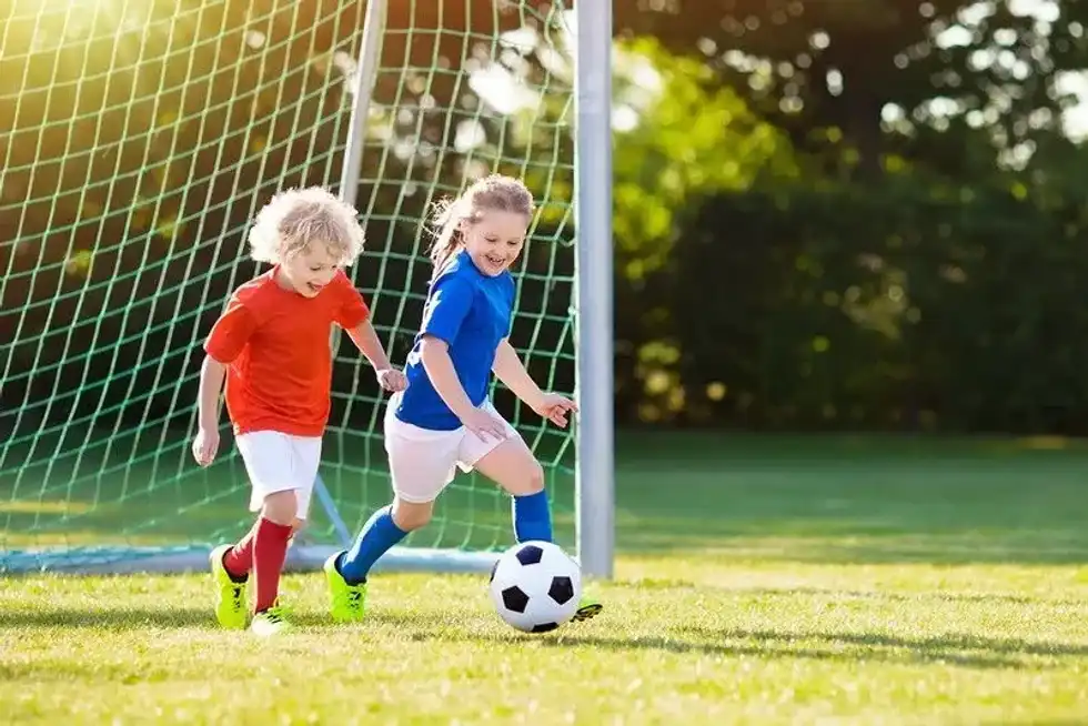 Kids play football.