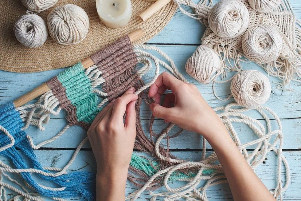 Knitting macrame on a wooden Board.