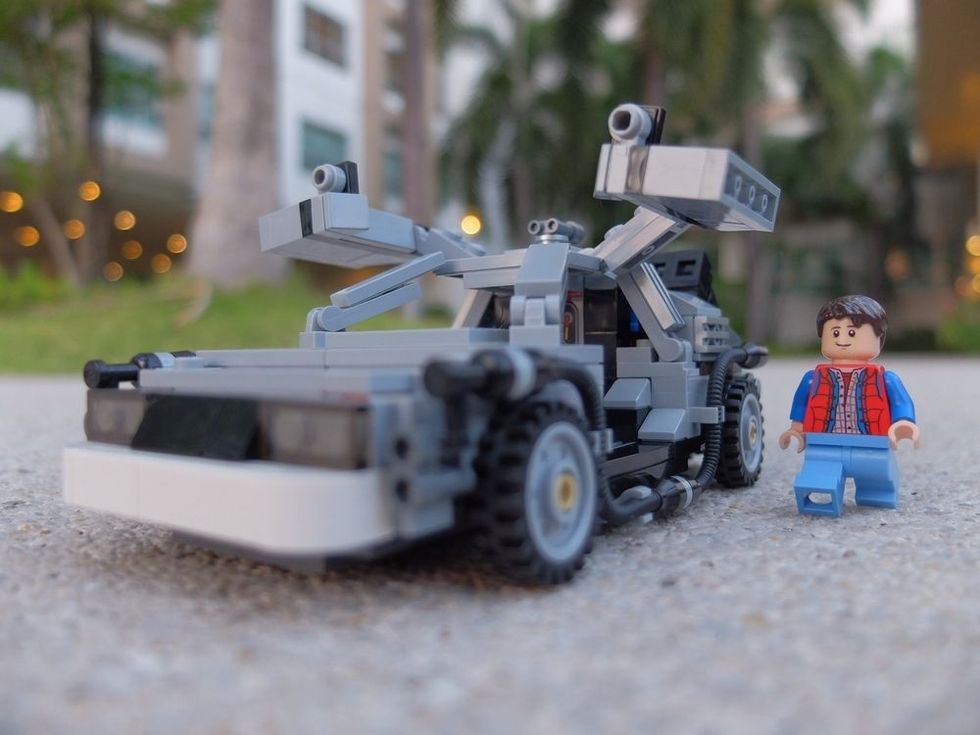 Lego Marty McFly walking to his DeLorean time machine parking in the garden. This set is from Back to the Future movie.