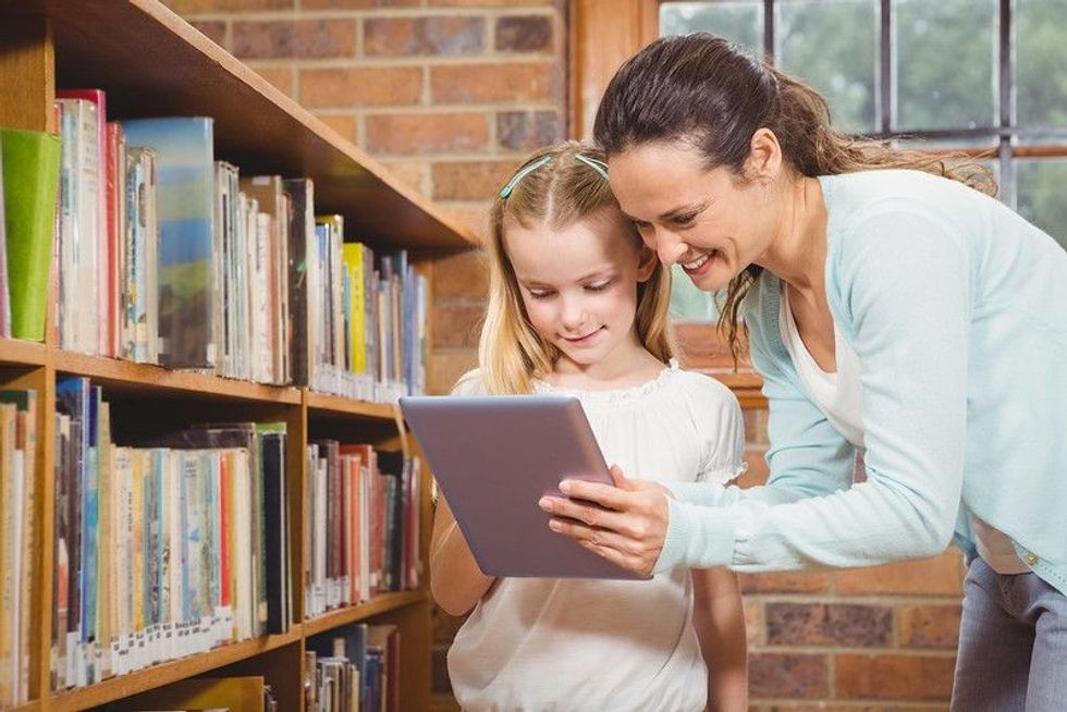 Librarian helping a girl.