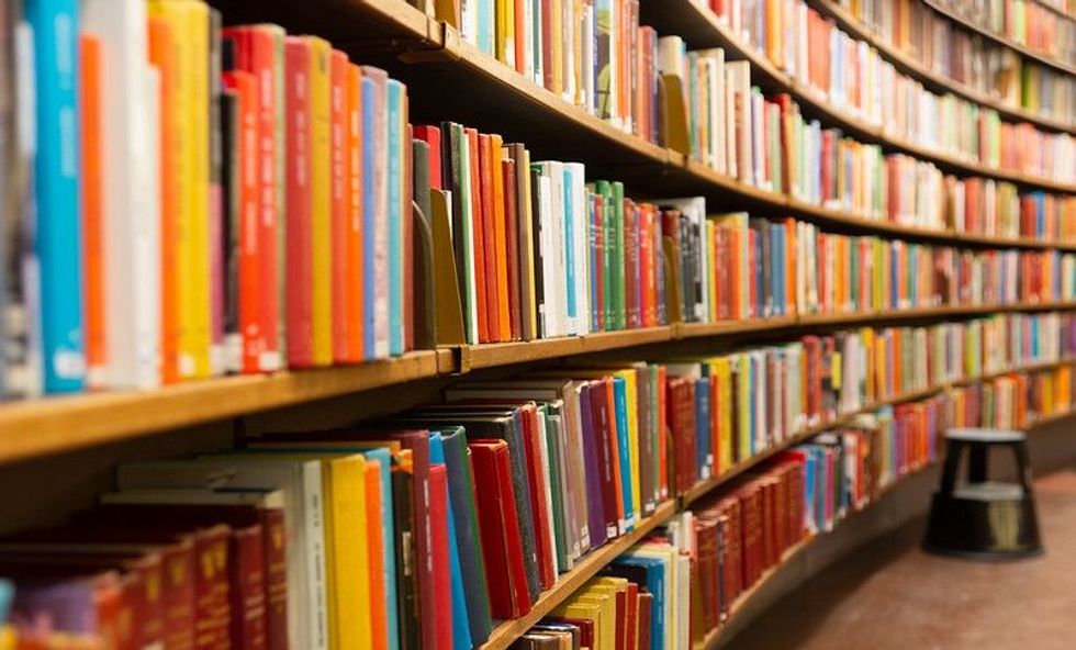 Library with multiple shelves and books. 