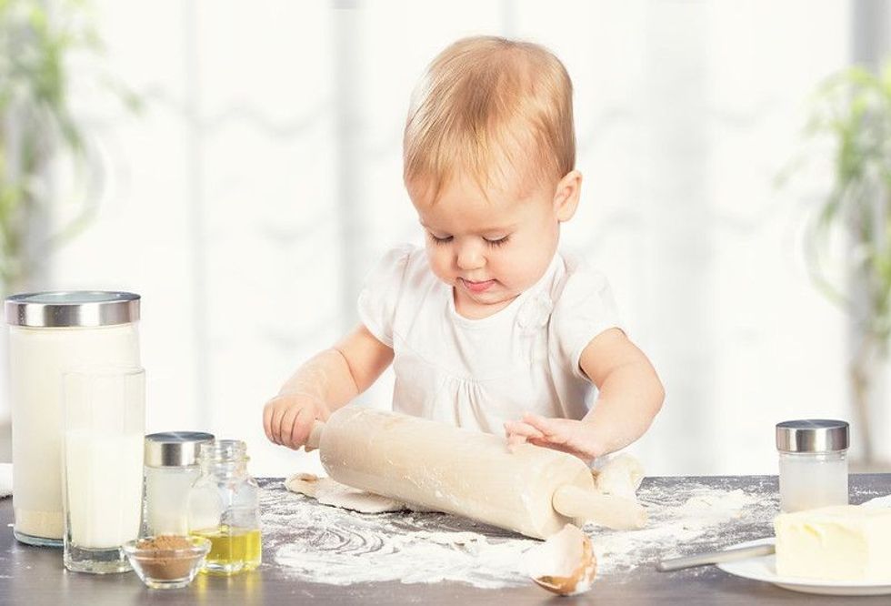 Little baby girl is cooking