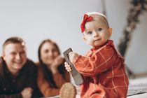 Little baby reaches for smartphone.
