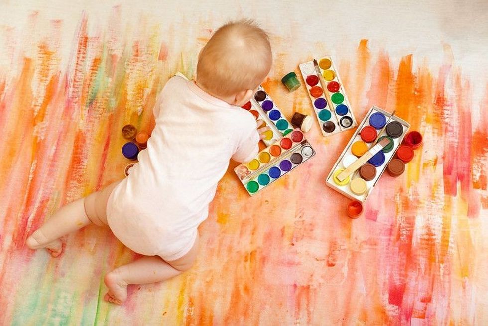 Little boy having fun with painting