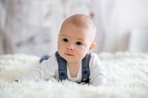 Little cute baby boy, playing with toys at home