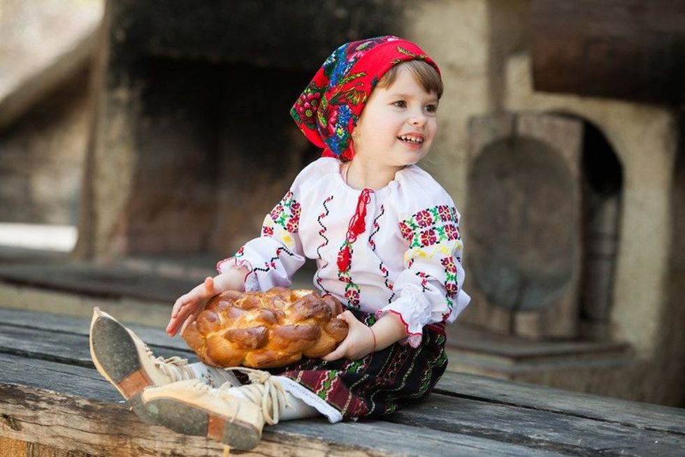 Little girl in a traditional romanian folk costume.