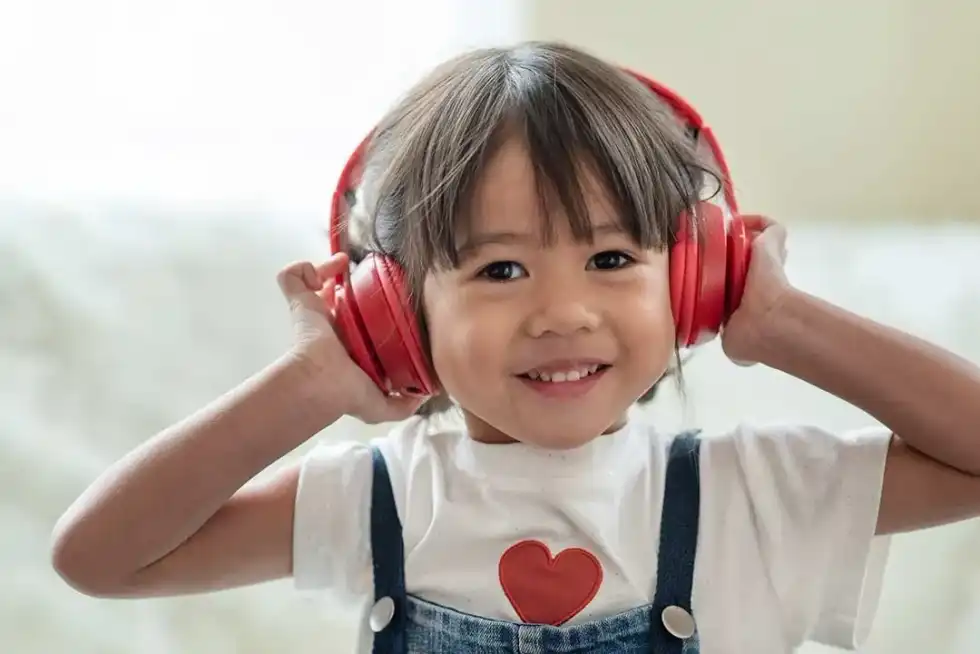 Little girl listening to a story on Audible.