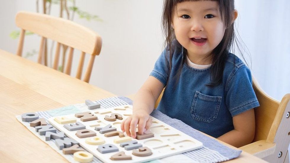 Little girl playing with alphabets