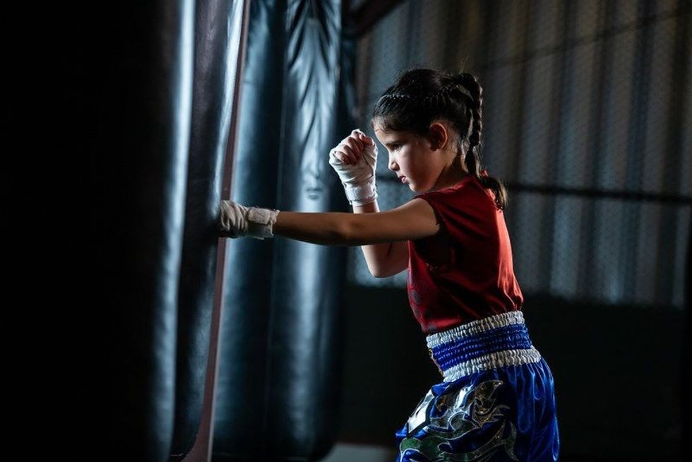 Little girl Thai boxing training is a self defense course, Muay Thai