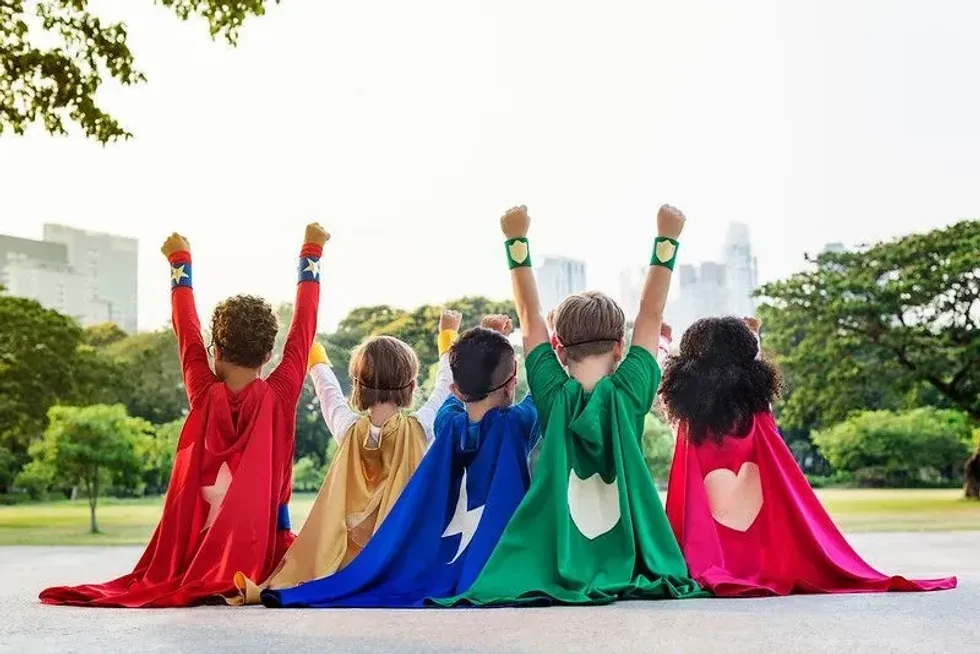 Little girls and boys dressed as superheroes