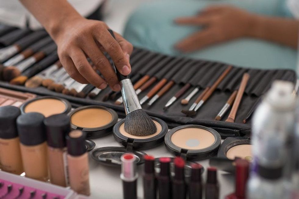 Makeup containers and brushes arranged on a table