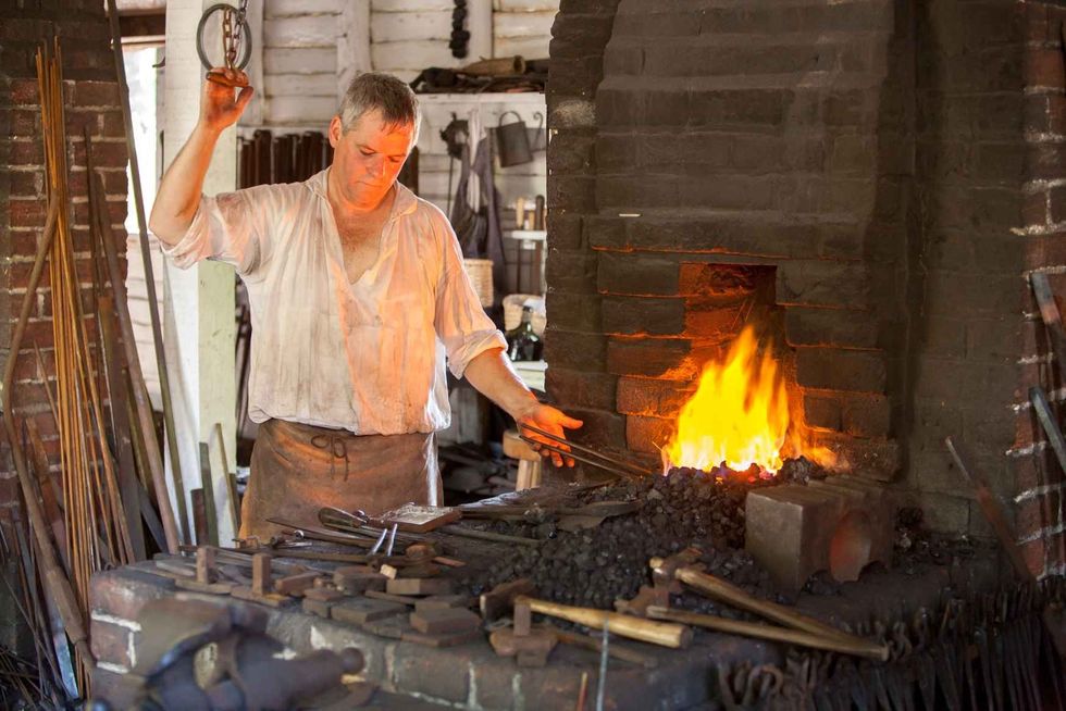 man dressed in period clothing is demonstrating