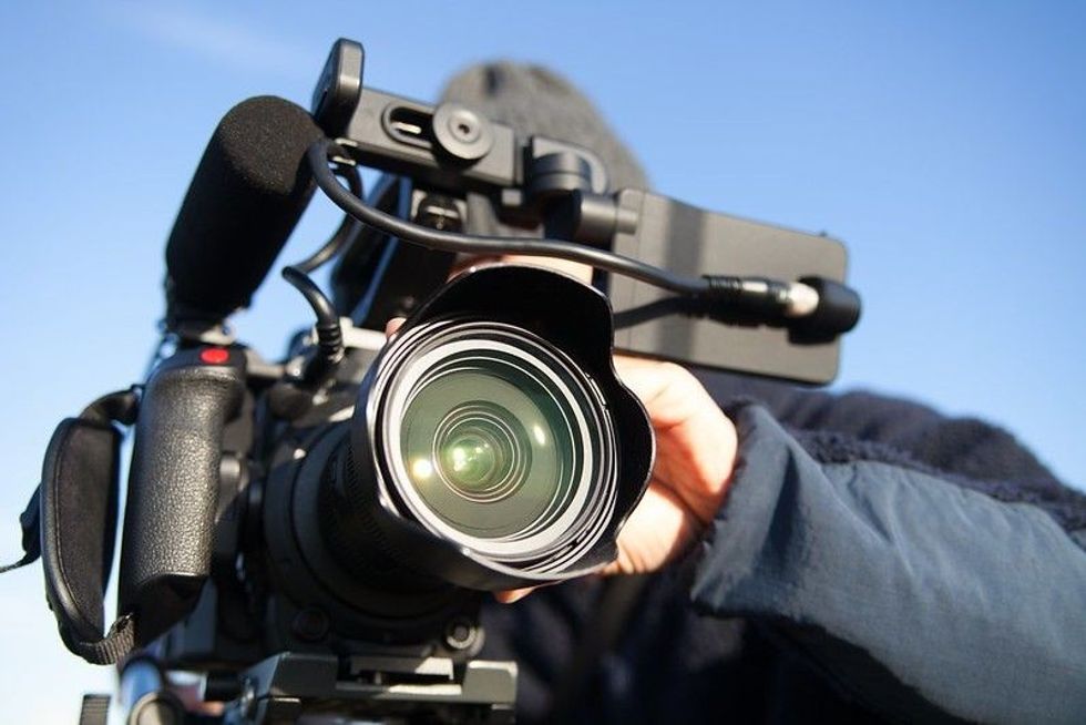 man filming with 4k camcorder