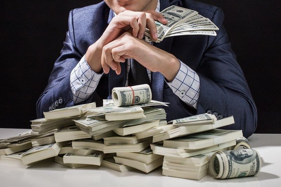 Man holding Money in hand at Black Background - Nicknames