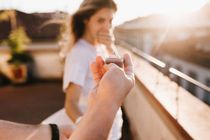 Man holding wedding ring in front of astonished
