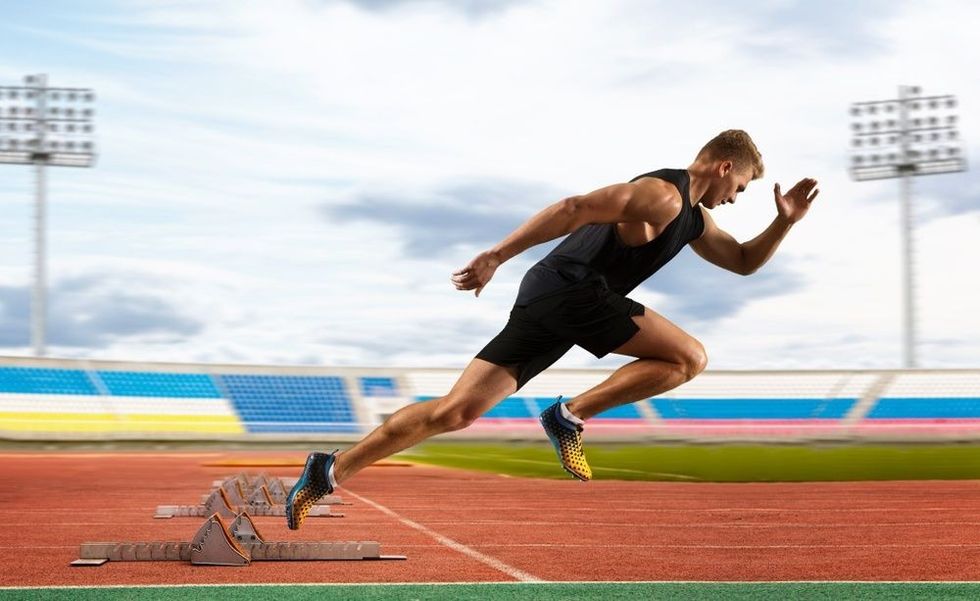 Man sprinter leaving starting blocks