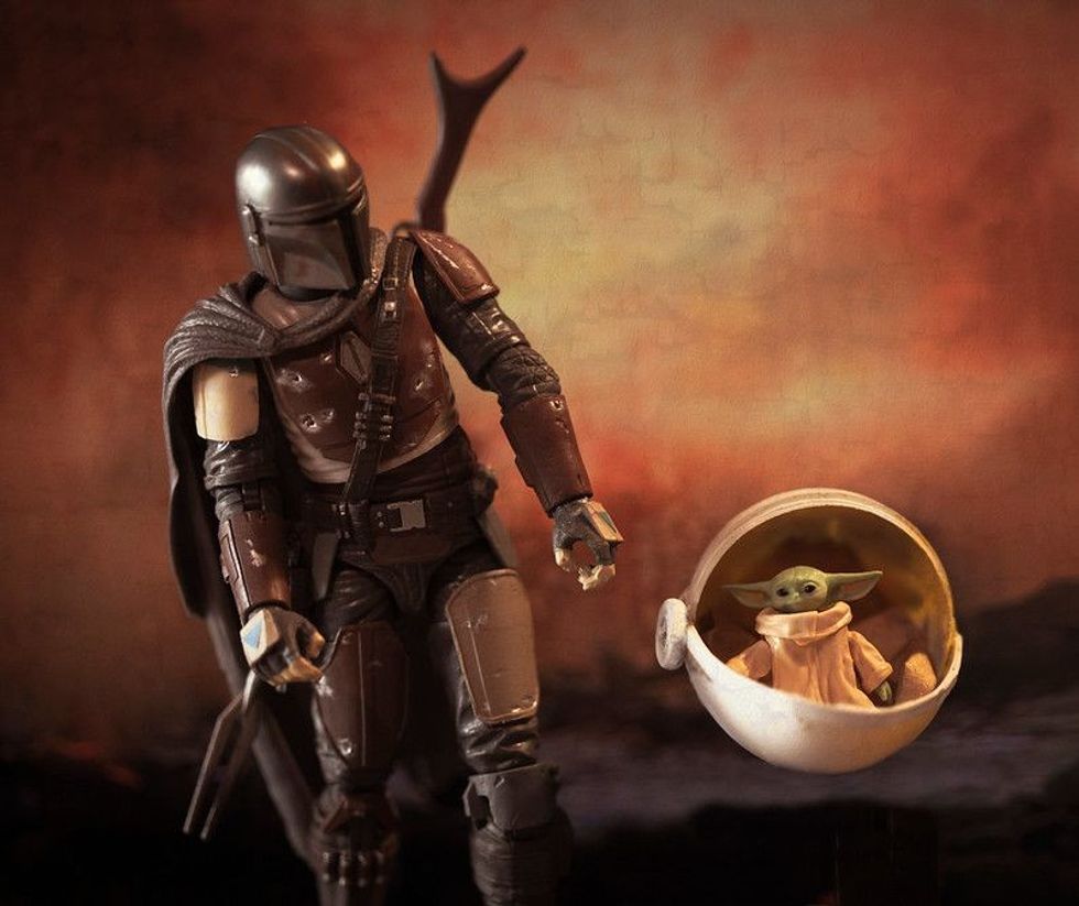 Mandalorian with The Child aka Yoda