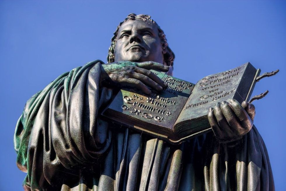 Martin Luther monument with bible in Wittenberg, Germany