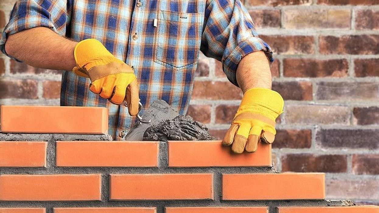 Mason laying the bricklayer while building a wall of the house - Nicknames