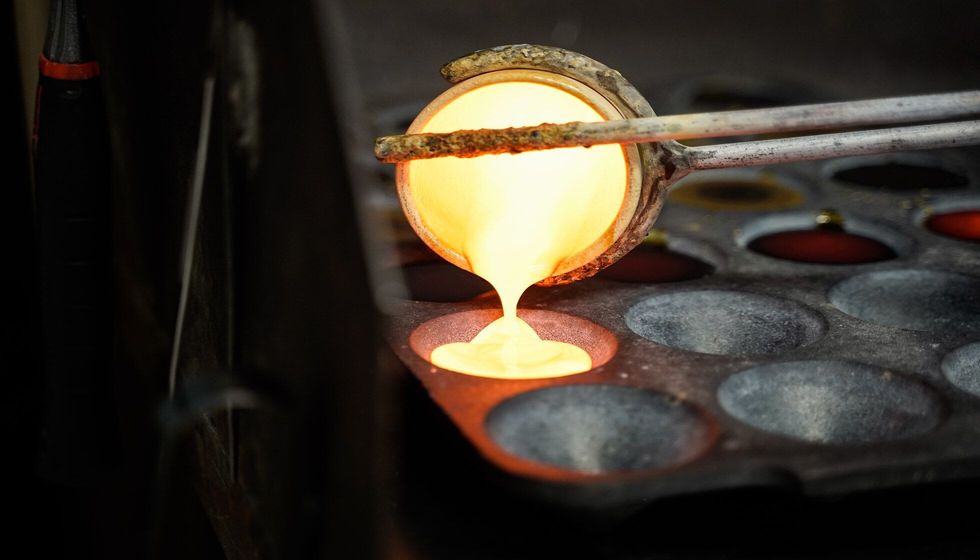 Metal in a .ceramic cup and poured into a form.