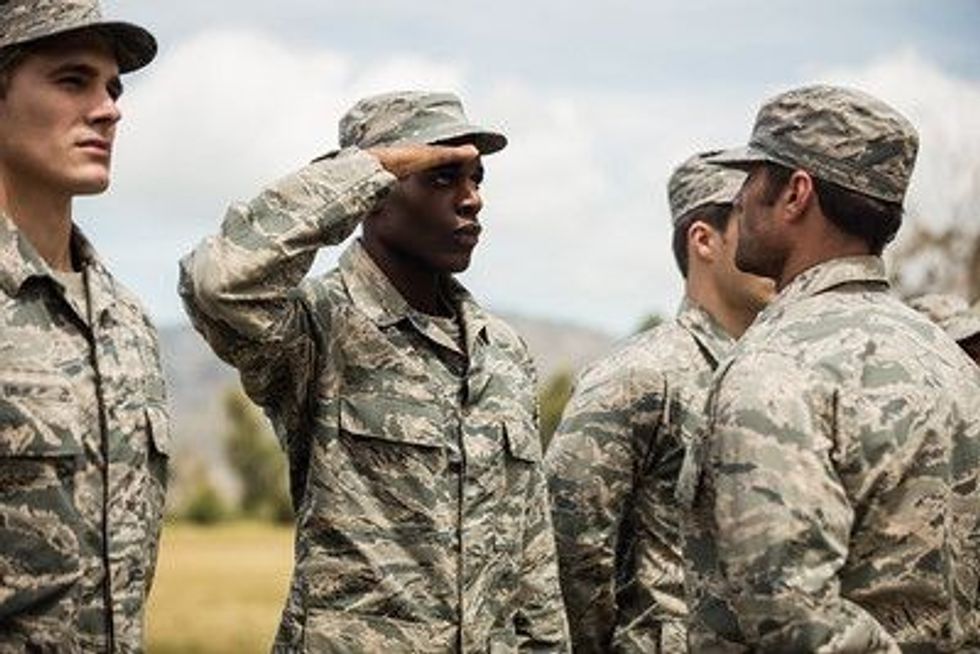 Military trainer giving training to military soldier at boot camp