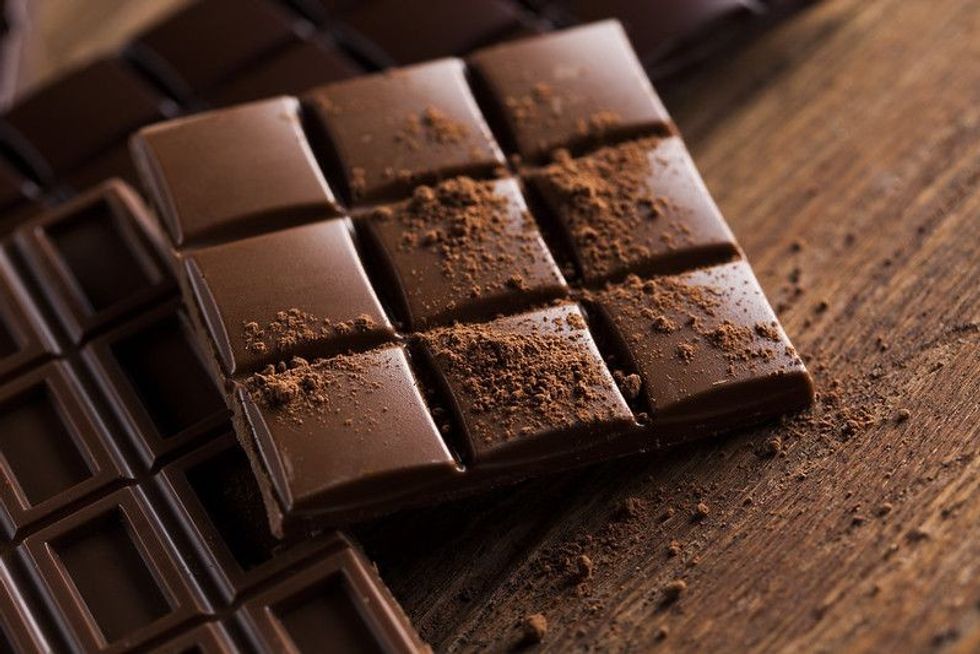 Milk and dark chocolate on a wooden table