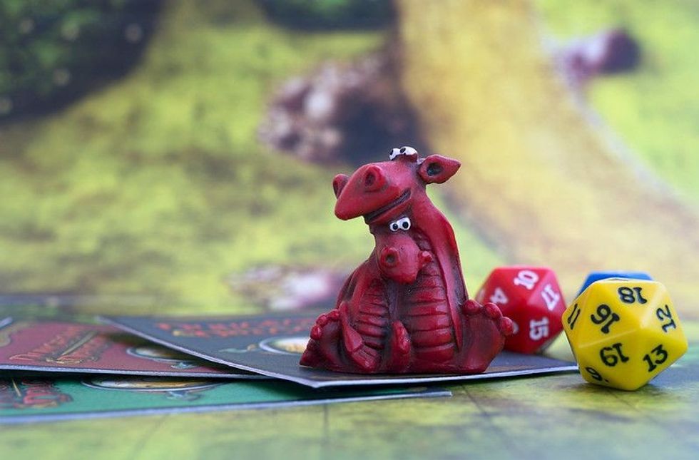 Miniature of two dragons, dices on a map: Dungeons and Dragons