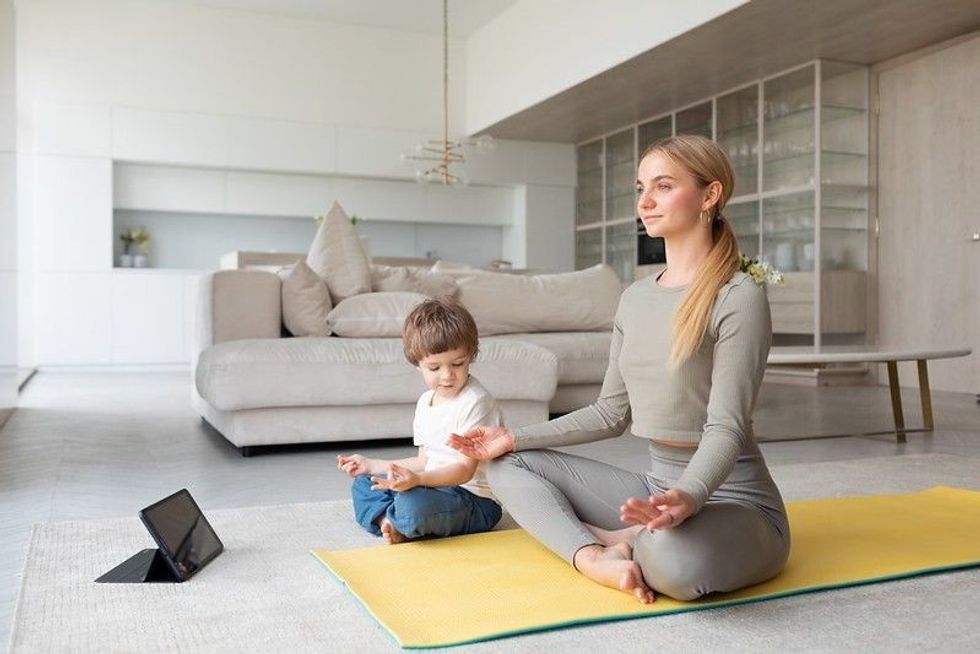 Mother and child practice yoga
