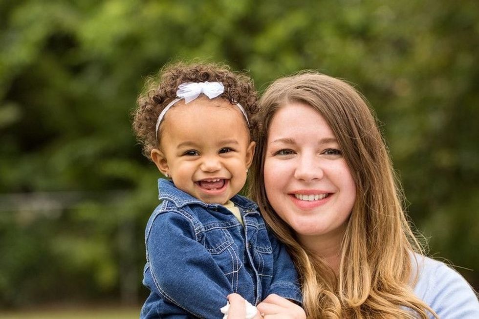 Mother and daughter having fun in park