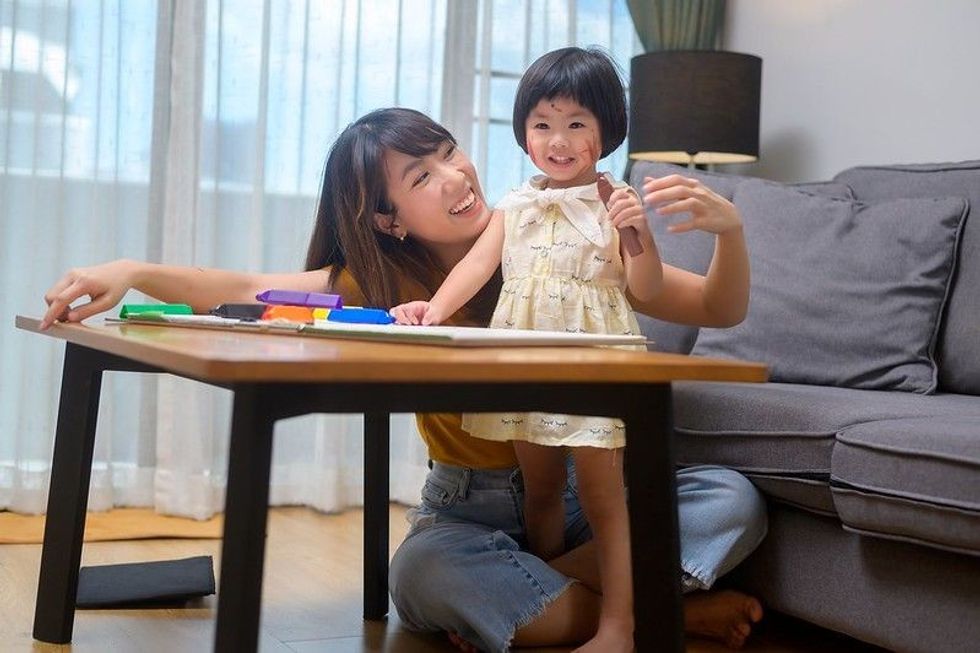 Mother and daughter having fun indoor