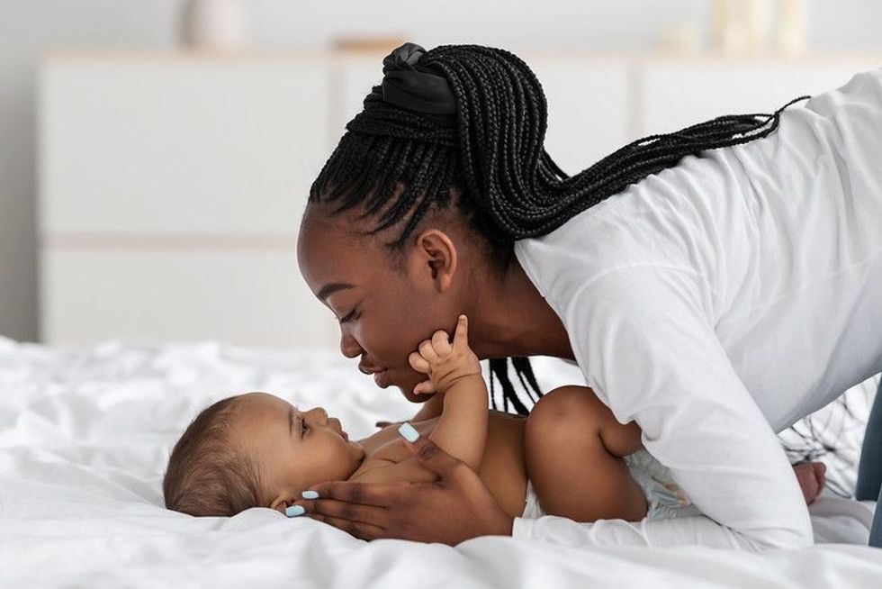 Mother playing with her baby
