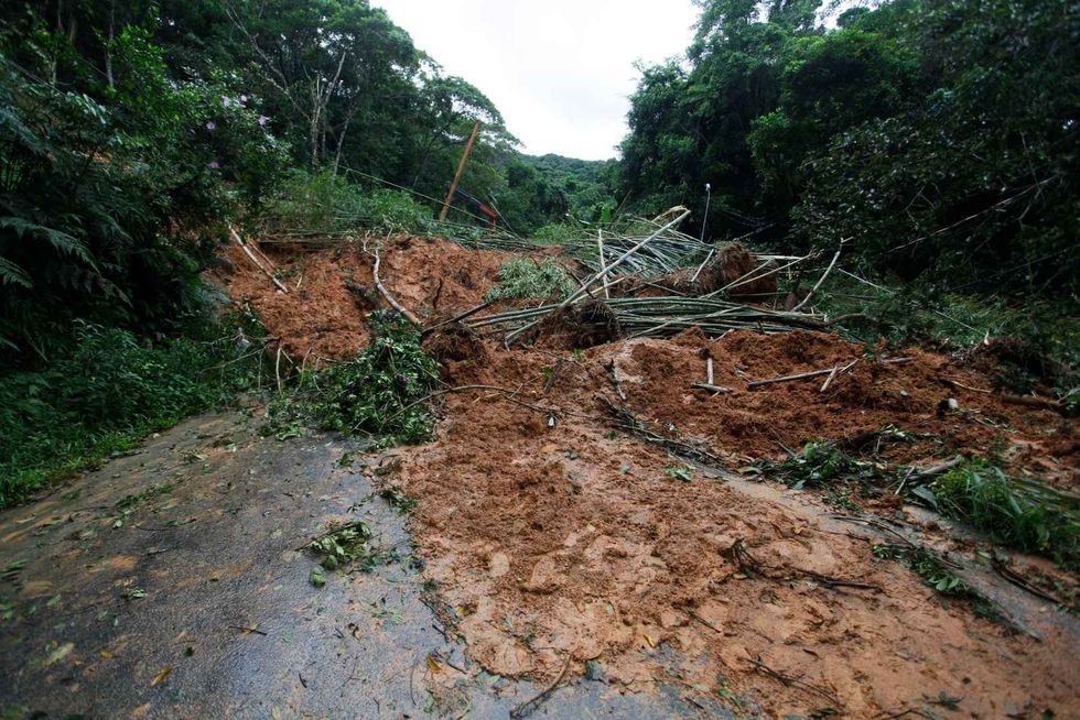 Mudslide and trees blocking a road on the coastal city