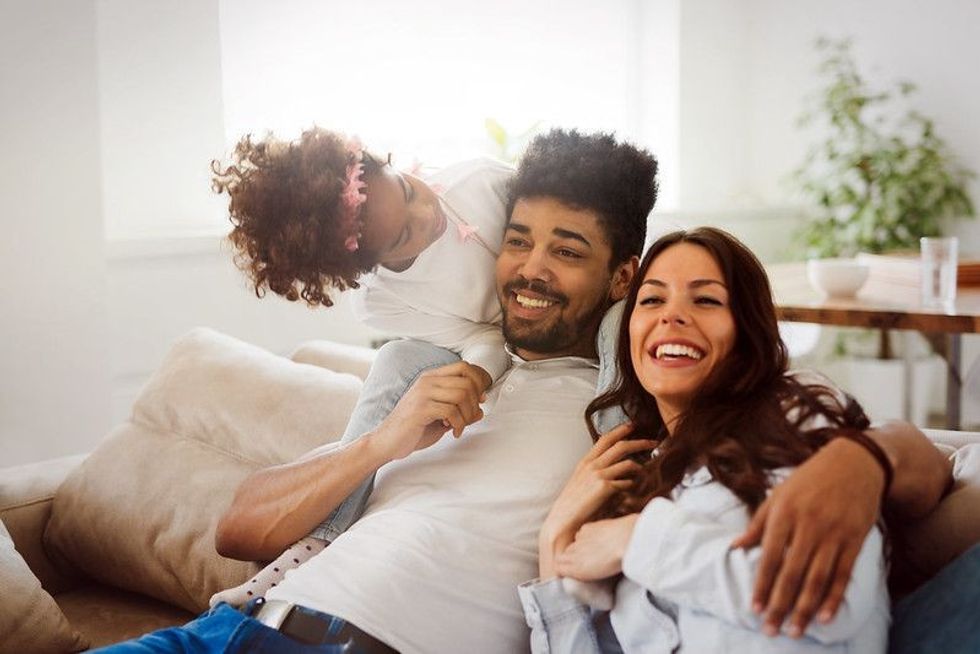 Multi racial Family of three enjoying family time at home