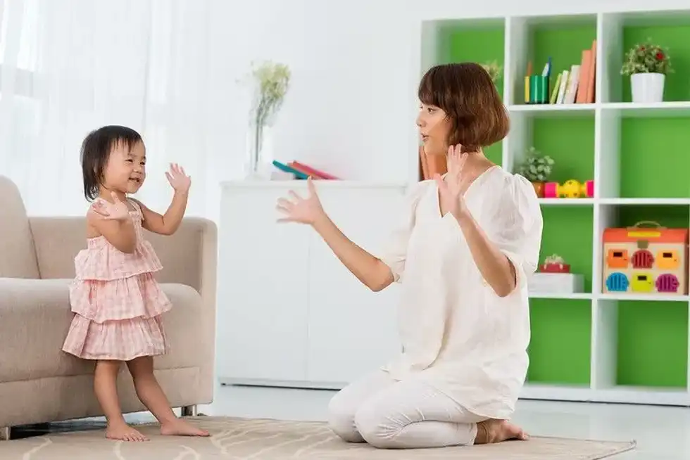 Mum and daughter enjoying online nursery rhymes