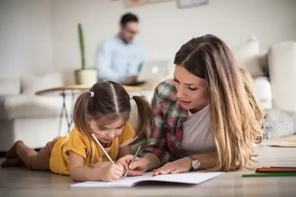 Mum helping daughter with noun phrases for KS2