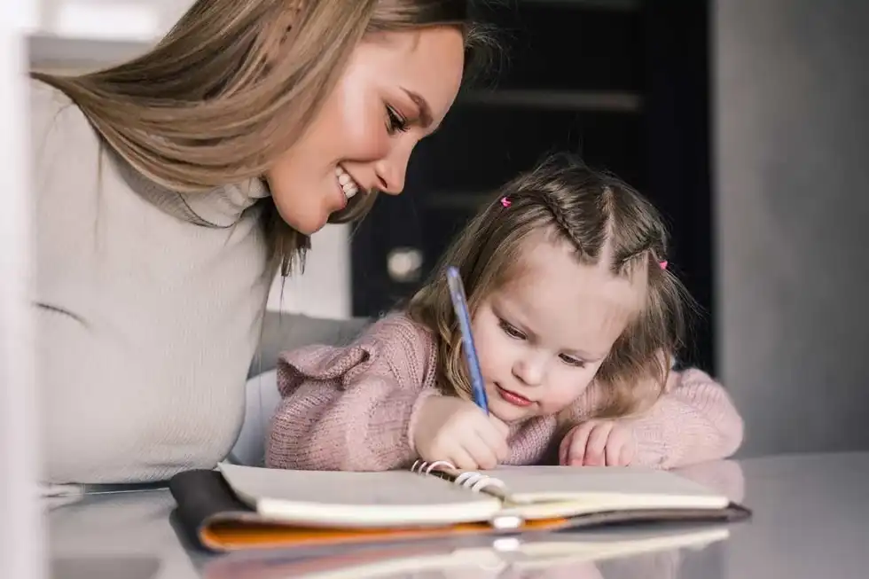 Mum helping her daughter learn about WW2 poems.