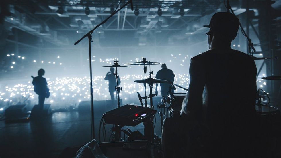 Music band group silhouette perform on a concert stage