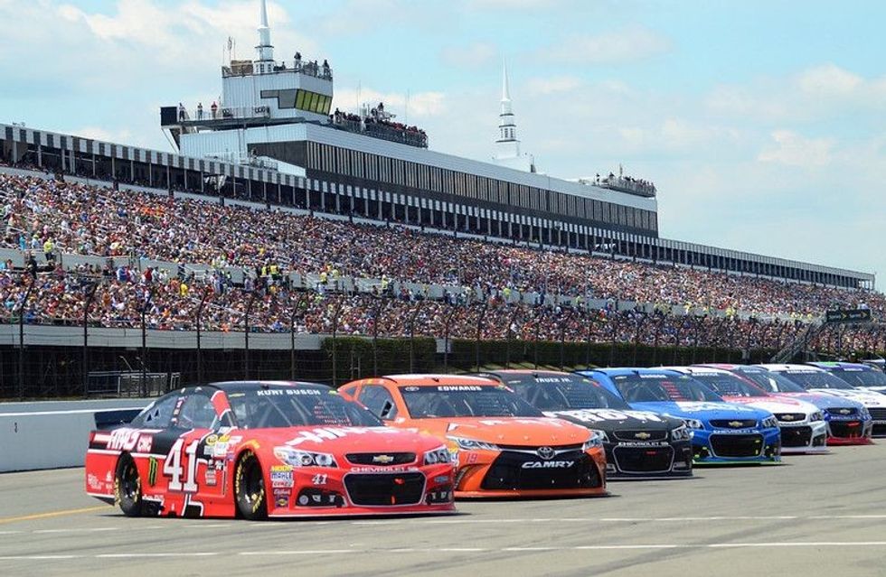 NASCAR Cup Series cars lined up on pit road