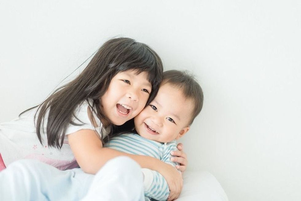 Nepali ethnicity kids hugging.