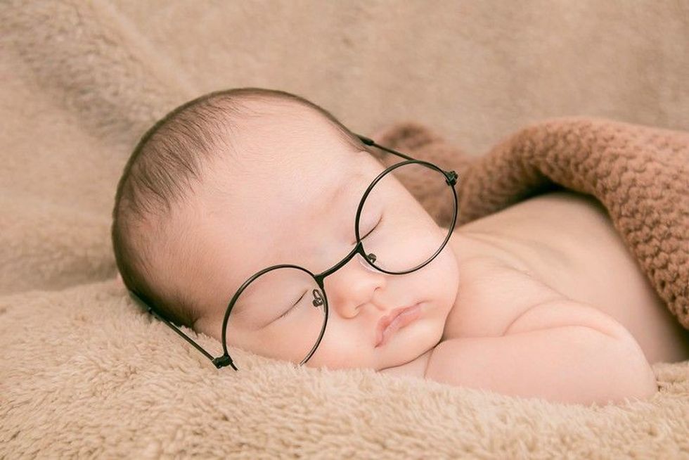 Newborn baby wearing glasses.