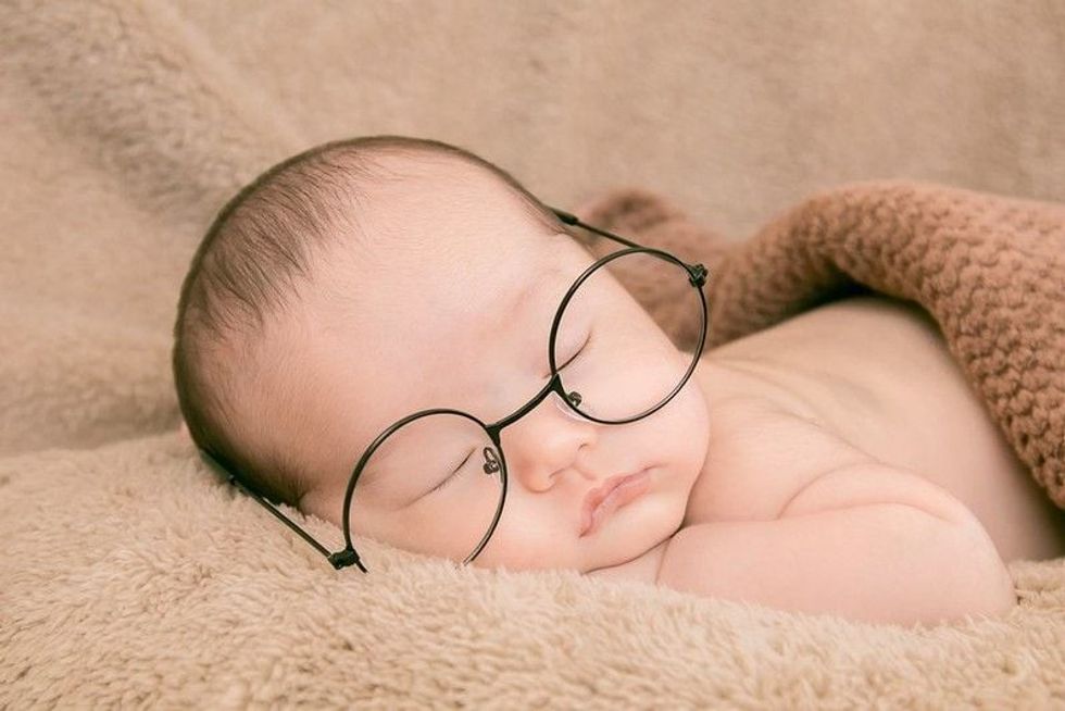 Newborn baby wearing glasses