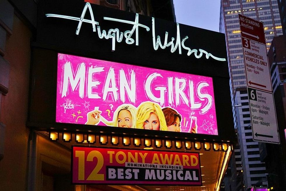 Night view of the August Wilson Theater showing Tina Fey's Mean Girls musical on Broadway in Manhattan. 